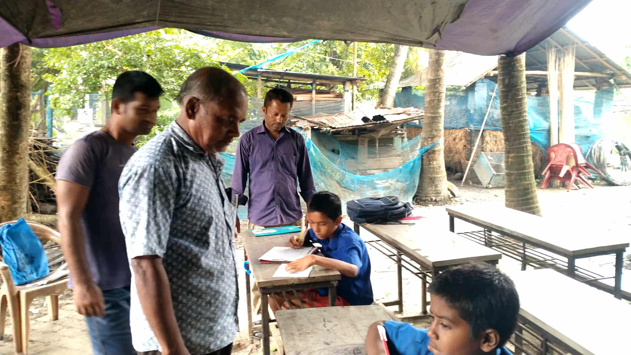 হাঁটু পানির মধ্যে ভেসে আছে মনিরামপুরের শিক্ষা ব্যবস্থা, তাবুতে চলছে পরীক্ষা